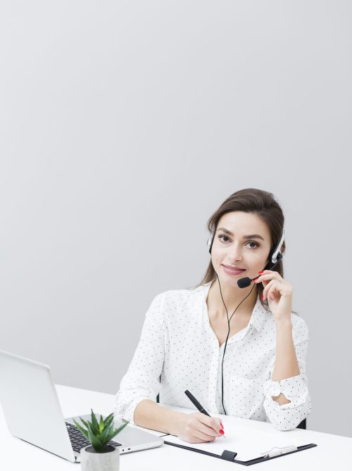 front view woman wearing headset working desk with laptop